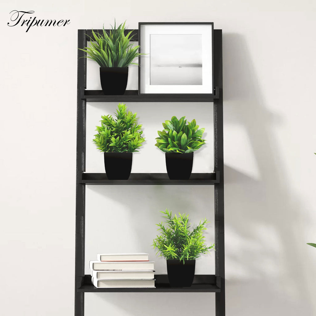 Artificial plants set in black pots, alternate angle