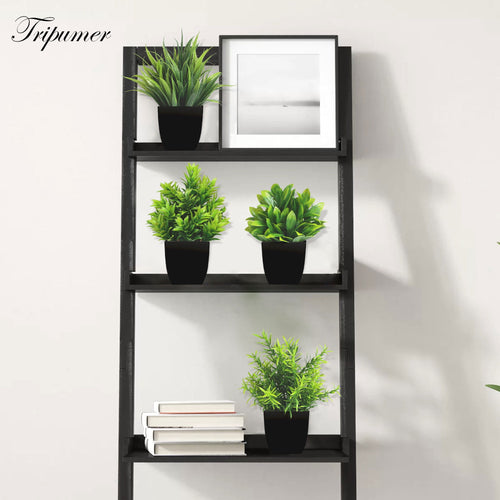 Artificial plants set in black pots, alternate angle