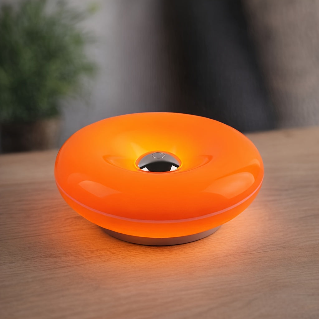 Orange donut-shaped touch desk lamp glowing