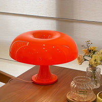 Orange LED mushroom table lamp on a side table