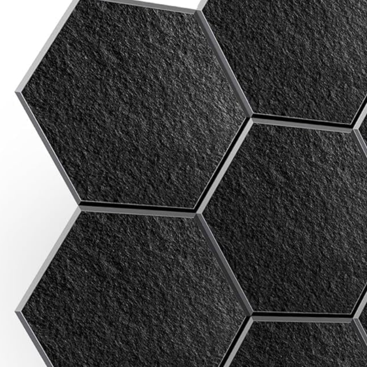 Black hexagon acoustic wall panels mounted on a wall, close-up of felt texture